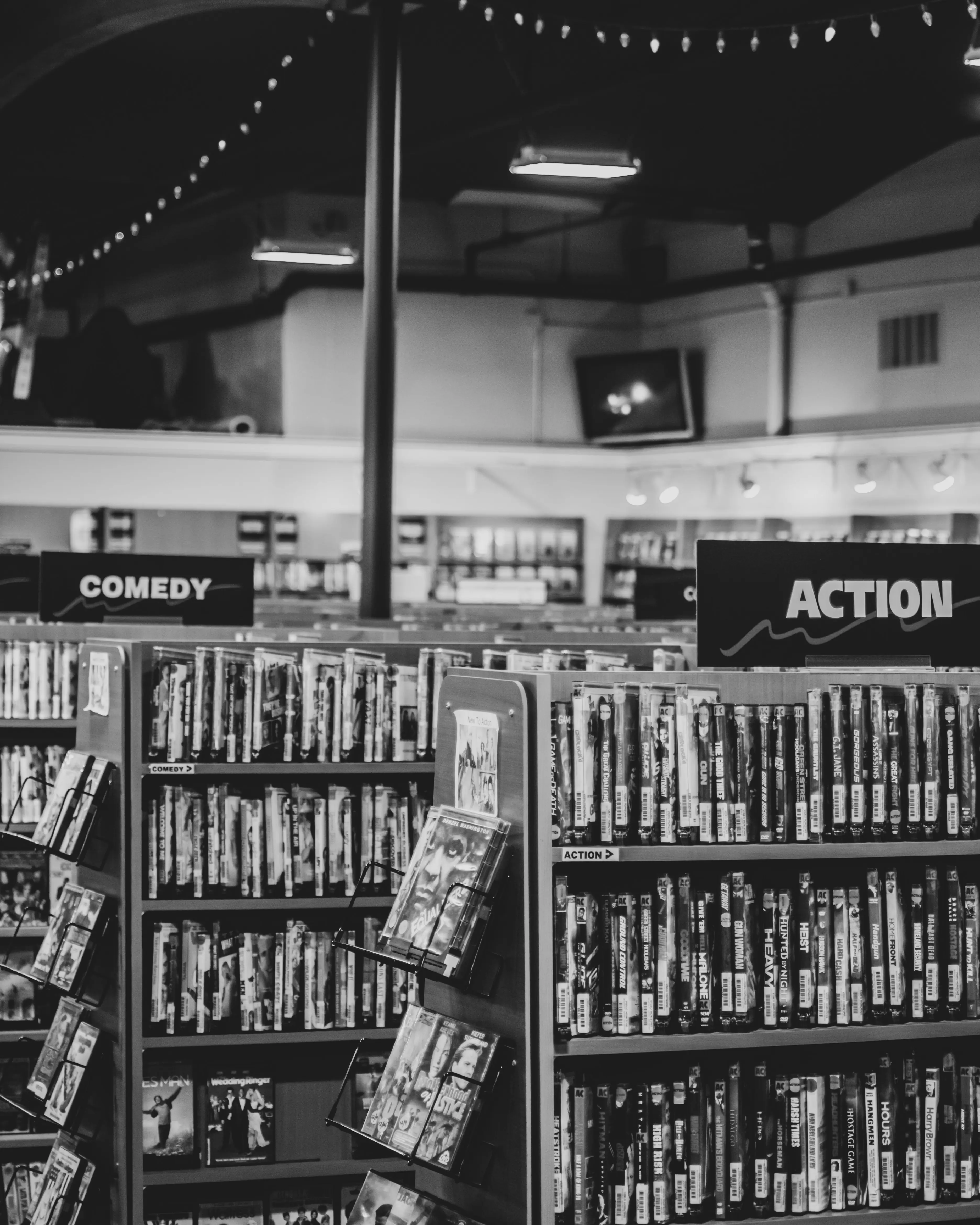 Black and white image of racks with DVD films