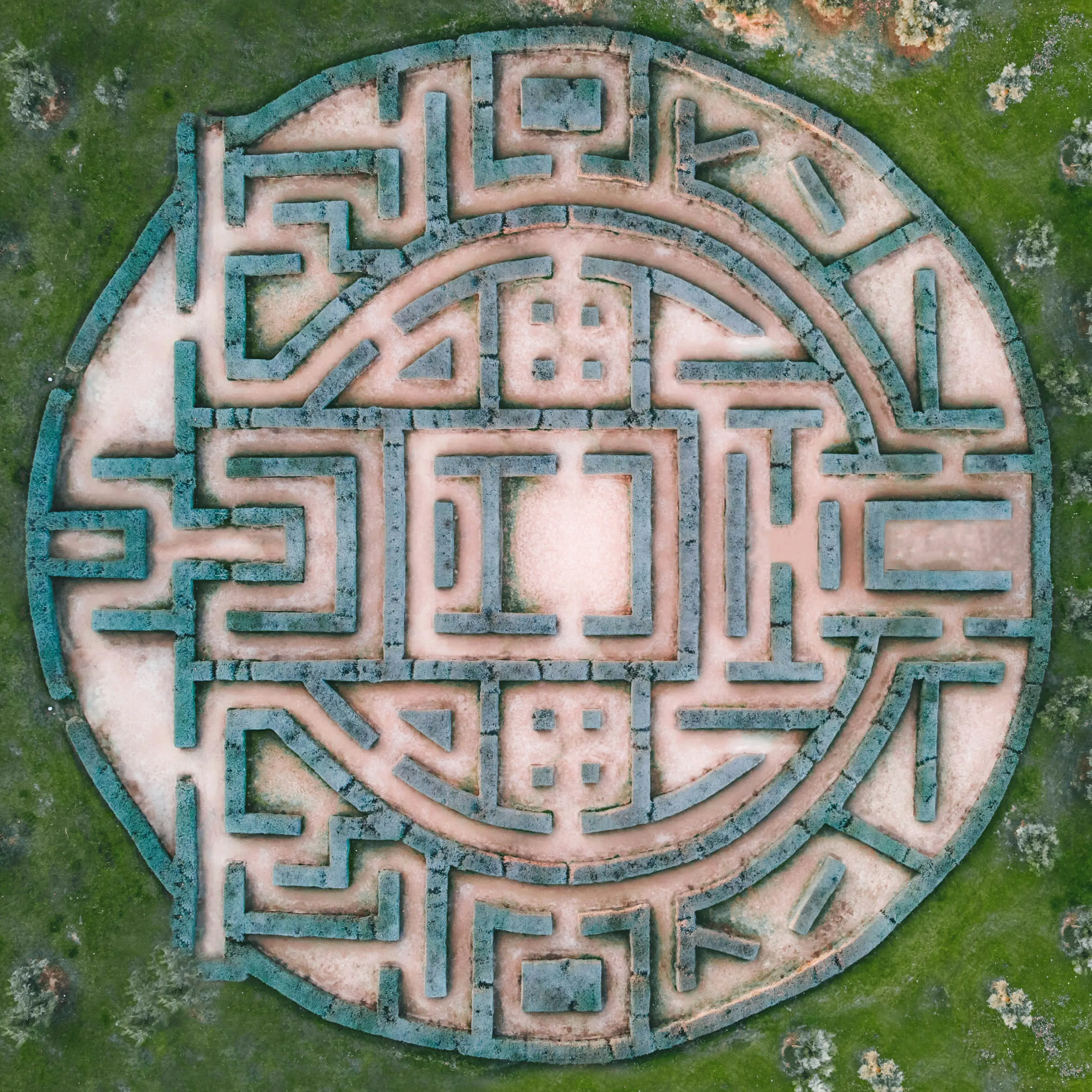 Top view of a round labyrinth with grass